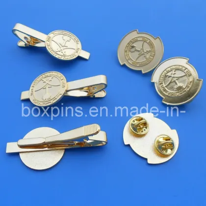 a Set of Metal Tie Cliff & Badges