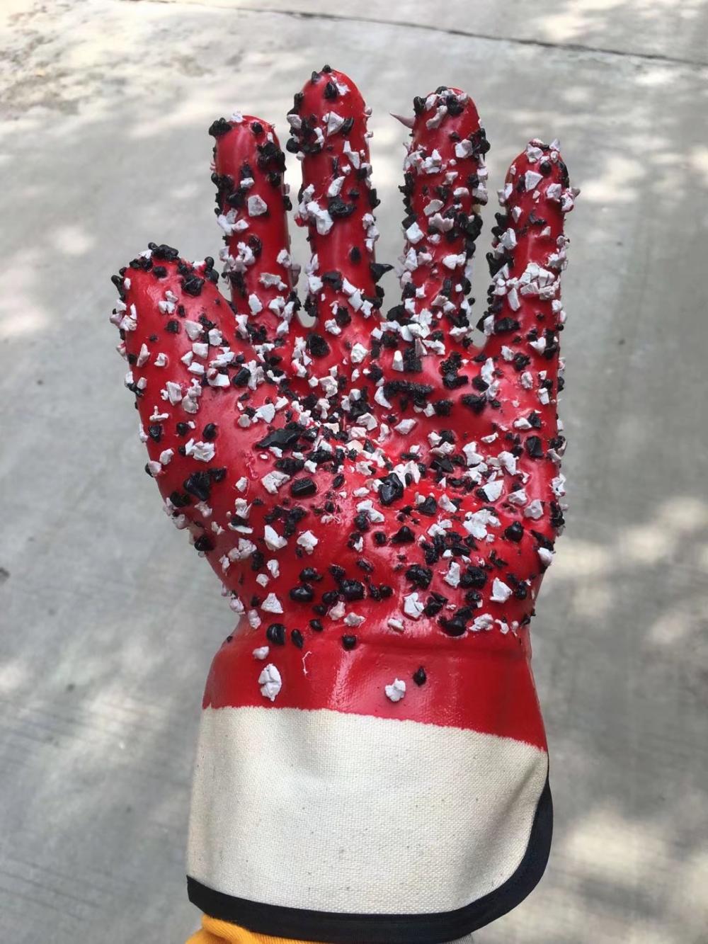 Red pvc gloves with chips on the palm