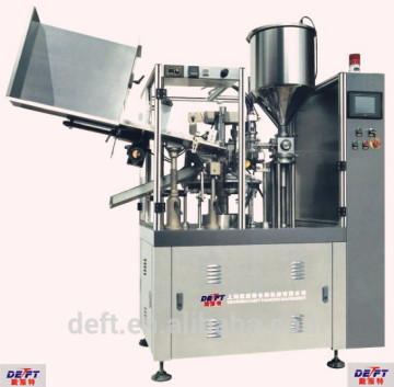 Laminated plastic tube filling and sealing machine