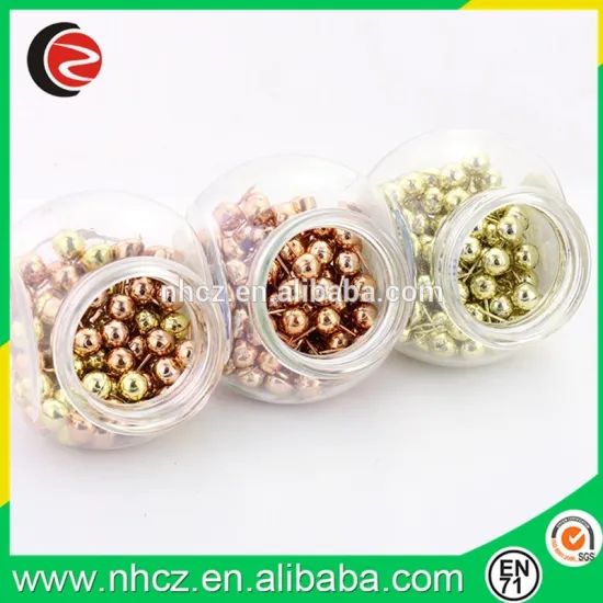 Round gold and rose gold ball push pin in glass bottle