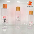 Botella con tapa de madera PET transparente para líquidos cosméticos
