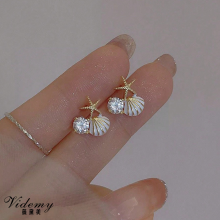 Pendientes de estrella de mar de diamantes de agua de concha blanca que gotea aceite