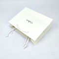 White Handle Paper Clothes Bag