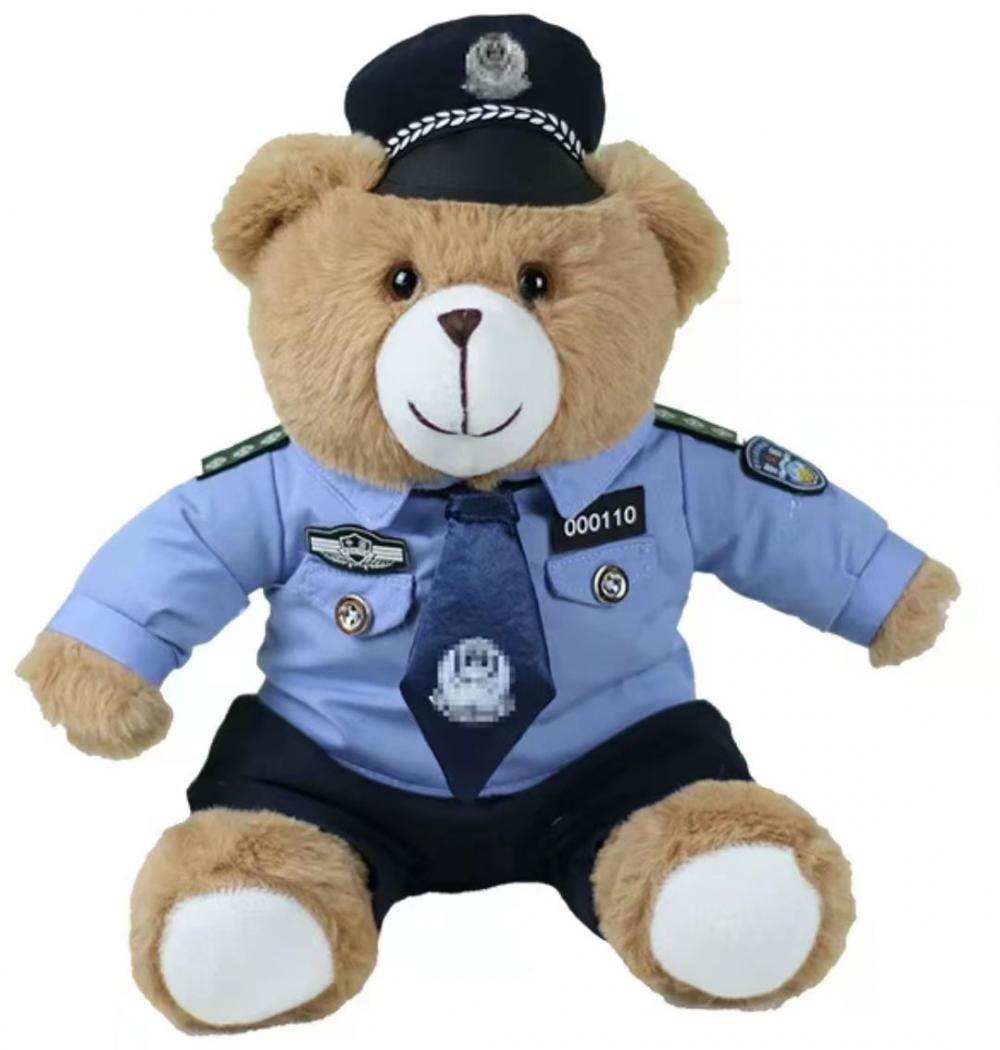 Dark brown stuffed teddy bear in police uniform