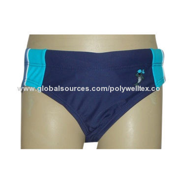 Boy's swim brief, in solid marine, with contrasted panels and pipings at two sides, a print on left