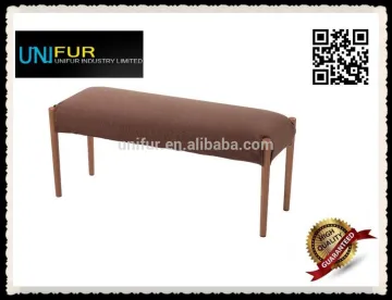 Upholstererd backless bench seating with wooden stools
