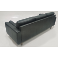 Light colored leather three person sofa
