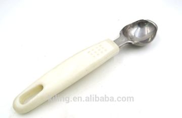 stainless steel ice cream spoon with white plastic handle