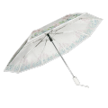 Paraguas plegable transparente con flor de hoja dibujada a mano