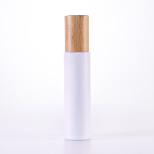 Botella de loción de vidrio blanco con tapa de bambú