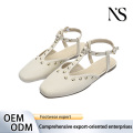 Sandalias beige con tira en T y adornos de remaches