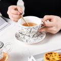 Taza de té de vidrio de té de cerámica europea con tetera y copa apilable de porcelana infusor en una porcelana una persona